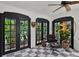 Bright living room featuring a unique bear accent piece, black trimmed doors and windows, and modern chair at 906 Alhambra Ct, Orlando, FL 32804