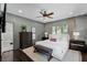Bedroom with gray walls, white bedding, and access to the bathroom at 906 Alhambra Ct, Orlando, FL 32804