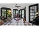Bright and modern office space with French doors, tiled floors, and stylish decor at 906 Alhambra Ct, Orlando, FL 32804