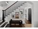 Elegant staircase with a dark wood railing and gallery wall decor at 906 Alhambra Ct, Orlando, FL 32804