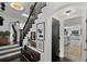 Beautiful staircase with a landing and gallery wall leading to an open concept living space at 906 Alhambra Ct, Orlando, FL 32804