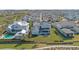 An aerial view of a charming neighborhood featuring houses with well-manicured lawns and a community pool at 907 Celadon St, Winter Garden, FL 34787