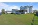 Spacious backyard featuring a manicured lawn, and a screened porch with outdoor seating at 907 Celadon St, Winter Garden, FL 34787