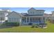 A serene backyard with a screened porch, an outdoor dining area, and a cozy fire pit at 907 Celadon St, Winter Garden, FL 34787