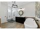 Modern bathroom featuring a glass shower, soaking tub, and stylish fixtures and finishes at 907 Celadon St, Winter Garden, FL 34787