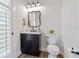 Elegant powder room with a marble countertop and decorative mirror at 907 Celadon St, Winter Garden, FL 34787