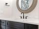 Close up of modern bathroom with a white countertop and dark cabinetry at 907 Celadon St, Winter Garden, FL 34787