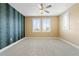 Inviting bedroom with a decorative accent wall and plush carpeting, illuminated by natural light from shuttered windows at 907 Celadon St, Winter Garden, FL 34787