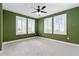 Bright, spacious bedroom with neutral carpet and white shutters on windows, offering natural light at 907 Celadon St, Winter Garden, FL 34787