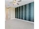 Spacious bedroom with patterned accent wall, soft carpeting, and neutral walls for a serene and comfortable ambiance at 907 Celadon St, Winter Garden, FL 34787