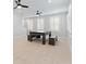 Bonus room featuring a bench dining table, carpeted flooring, three windows, and two ceiling fans at 907 Celadon St, Winter Garden, FL 34787