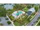 Aerial view of community pool with ample seating, a clubhouse, and nearby amenities at 907 Celadon St, Winter Garden, FL 34787