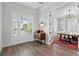 Bright foyer with wood floors, French doors leading to an office, and a view of the front yard at 907 Celadon St, Winter Garden, FL 34787