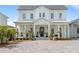 Charming home with a welcoming front porch, featuring rocking chairs and lush landscaping at 907 Celadon St, Winter Garden, FL 34787