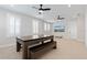 Game room with large table and bench seating, multiple ceiling fans, and a wall mounted TV at 907 Celadon St, Winter Garden, FL 34787