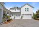 Spacious three-car garage showcasing white doors, a brick driveway, and meticulous landscaping at 907 Celadon St, Winter Garden, FL 34787