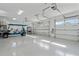 Clean, well-lit garage featuring epoxy floors, ample storage space, and an electric golf cart at 907 Celadon St, Winter Garden, FL 34787