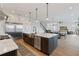 This open kitchen features modern appliances, sleek countertops, and a spacious island for entertaining at 907 Celadon St, Winter Garden, FL 34787