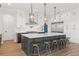 Kitchen featuring white cabinets, a large island with seating, and stainless steel appliances at 907 Celadon St, Winter Garden, FL 34787