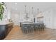 A modern kitchen with white cabinets, a stainless steel refrigerator, a large island, and pendant lighting at 907 Celadon St, Winter Garden, FL 34787