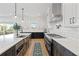 Bright kitchen featuring white cabinets, stainless appliances, a center island, and wood-look tile flooring at 907 Celadon St, Winter Garden, FL 34787