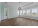 Bright living room featuring luxury floors, large windows, and plantation shutters at 907 Celadon St, Winter Garden, FL 34787