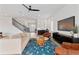 Bright living room with a unique rug, a shiplap wall, a bar, and access to a staircase and foyer at 907 Celadon St, Winter Garden, FL 34787
