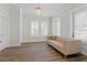 Bright and airy living room with a comfortable couch and plenty of natural light from the shuttered windows at 907 Celadon St, Winter Garden, FL 34787