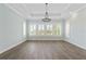 Bright living room featuring luxury floors, large windows, and plantation shutters at 907 Celadon St, Winter Garden, FL 34787