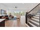 Open concept living room boasts hardwood floors, shiplap walls, and a large sliding glass door at 907 Celadon St, Winter Garden, FL 34787