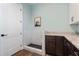 Convenient mud room featuring a dog washing station, wood floors, and cabinet storage at 907 Celadon St, Winter Garden, FL 34787