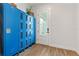 Charming mud room with blue lockers and a door with glass panels for natural light at 907 Celadon St, Winter Garden, FL 34787