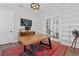 Home office featuring a large wooden desk, built-in shelving, and a red patterned rug at 907 Celadon St, Winter Garden, FL 34787
