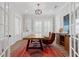 Bright office space with custom built-ins, wood desk, and unique accent rug at 907 Celadon St, Winter Garden, FL 34787