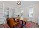 Office with a large wooden desk, leather chair, and a Persian rug at 907 Celadon St, Winter Garden, FL 34787