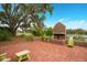 Brick patio with fireplace and Adirondack chairs overlooking the water, perfect for outdoor gatherings at 907 Celadon St, Winter Garden, FL 34787