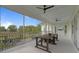 Covered patio with a dining table, outdoor seating, and views of the backyard at 907 Celadon St, Winter Garden, FL 34787
