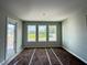 Bedroom with three large windows with views of the trees at 960 Hawksnest Pt, Oviedo, FL 32765