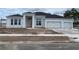 New construction home featuring a three-car garage and a modern white exterior at 960 Hawksnest Pt, Oviedo, FL 32765