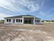 Rear exterior of home featuring sliding glass doors and large windows at 960 Hawksnest Pt, Oviedo, FL 32765