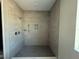 A walk-in shower features modern tilework, rain shower head and storage niche at 960 Hawksnest Pt, Oviedo, FL 32765