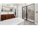 Modern bathroom features a standalone tub and a glass enclosed shower with a tiled shower at 9574 Meadow Hunt Way, Winter Garden, FL 34787