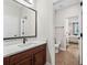 Convenient bathroom features a large mirror and sink and a view of the toilet at 9574 Meadow Hunt Way, Winter Garden, FL 34787