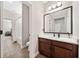 Well-lit bathroom features a modern vanity, sleek mirror and a tub-shower combo at 9574 Meadow Hunt Way, Winter Garden, FL 34787
