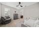 Relaxing bedroom featuring two sofas and a view of the bathroom at 9574 Meadow Hunt Way, Winter Garden, FL 34787