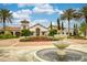 Elegant clubhouse entrance with water feature, showcasing meticulous landscaping and architectural charm at 9574 Meadow Hunt Way, Winter Garden, FL 34787