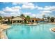 Stunning community pool with resort-style amenities, featuring a splash pad and ample seating for residents at 9574 Meadow Hunt Way, Winter Garden, FL 34787