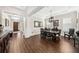 Dining room with hardwood floors, decorative mirror, and a glimpse of the entryway at 9574 Meadow Hunt Way, Winter Garden, FL 34787