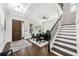 Beautiful home entryway showcasing hardwood floors, staircase, and an office area at 9574 Meadow Hunt Way, Winter Garden, FL 34787