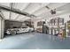 Organized garage with epoxy flooring and plenty of storage cabinets at 9574 Meadow Hunt Way, Winter Garden, FL 34787